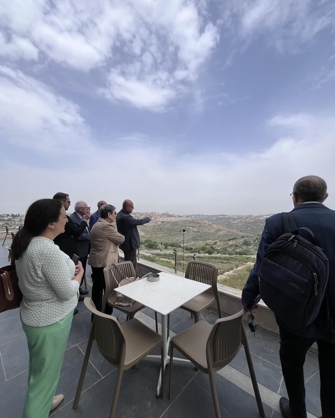 Two people on the terrace looking out across the hills